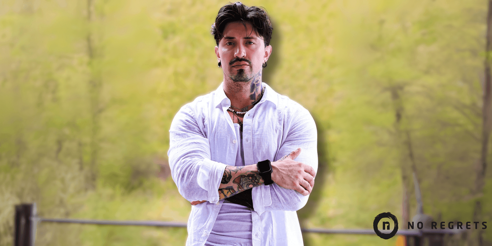 Andy Ramos, a renowned tattoo artist at No Regrets Studios, showcasing his mastery of black and grey realism tattoos.
