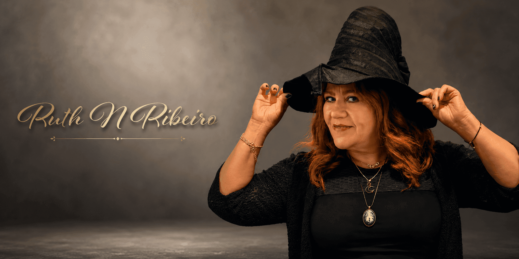 Author Ruth N Ribeiro wearing a witch’s hat in a promotional portrait highlighting her mystical literary brand.