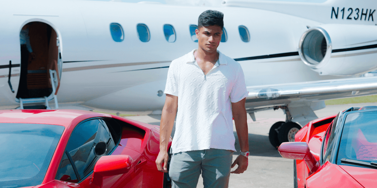 Vadim Barboza with exotic cars and a private jet, representing iExotic's luxury travel services.