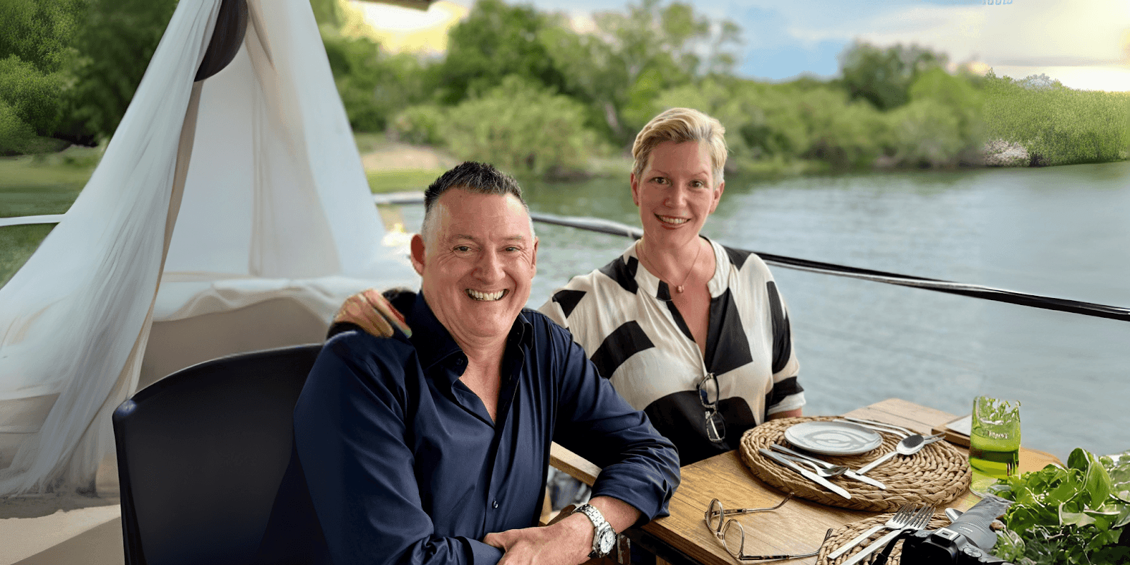 Wayne and Sally Schmidt, digital nomads and founders of Travel Dine Stay, enjoy a relaxed moment together at a scenic waterfront restaurant. Their business allows them to work part-time while traveling, offering marketing consulting to accounting firms. Their story inspires others to embrace a life of adventure, freedom, and flexibility, redefining the concept of retirement.