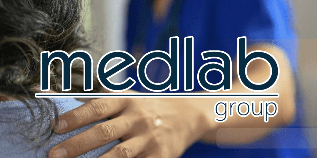 Medlab Group logo with a healthcare professional’s hand on a patient’s shoulder, symbolizing compassionate, patient-centered care.