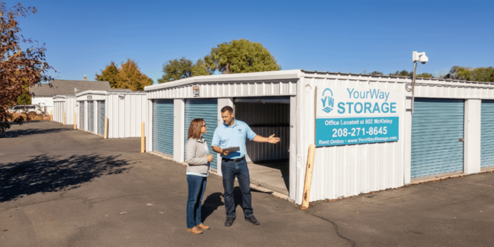 Staff member and customer discussing storage options outside the YourWay Storage McKinley facility in Pocatello."