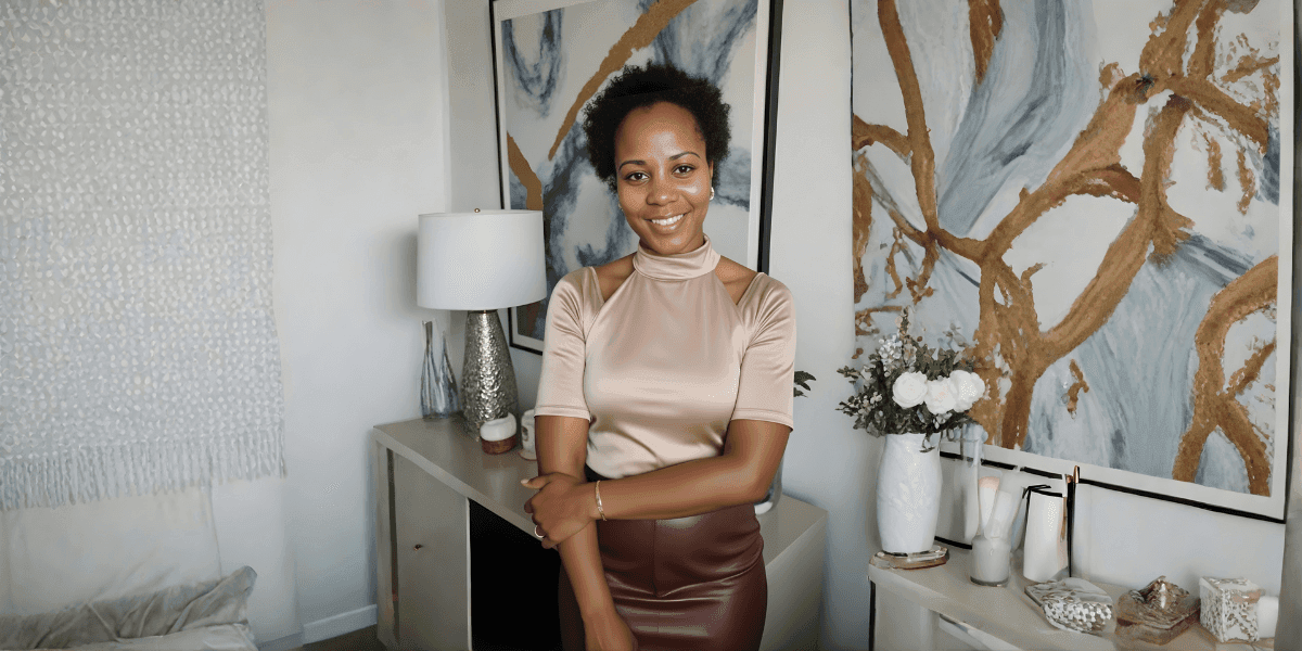 Smiling woman standing in a stylish modern living room with abstract artwork and elegant décor.