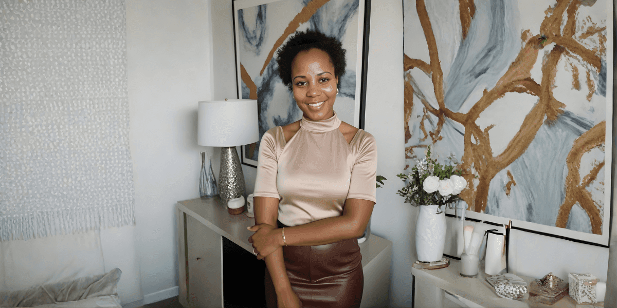 Smiling woman standing in a stylish modern living room with abstract artwork and elegant décor.