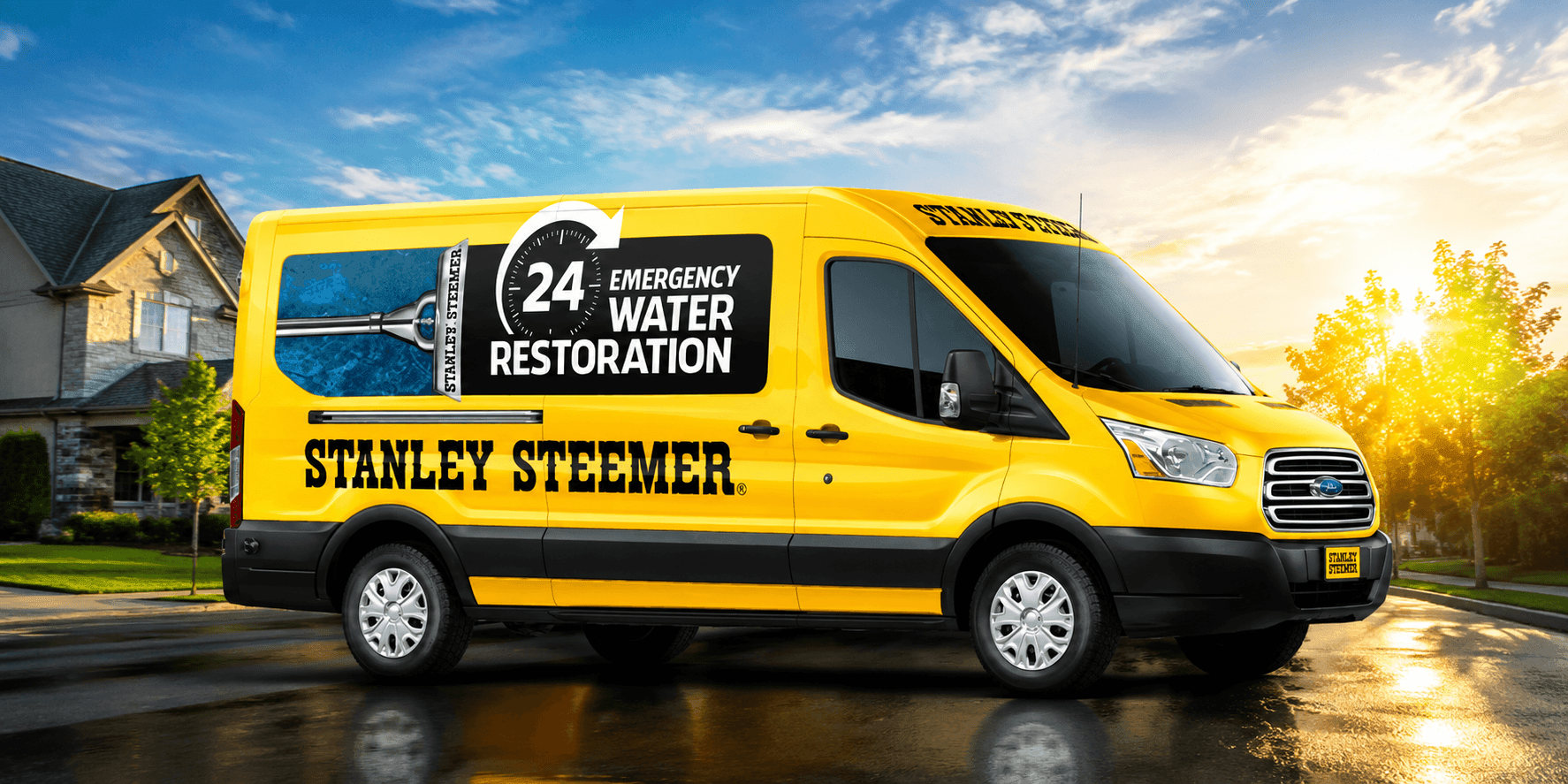 Stanley Steemer emergency water restoration van parked in a residential neighborhood.