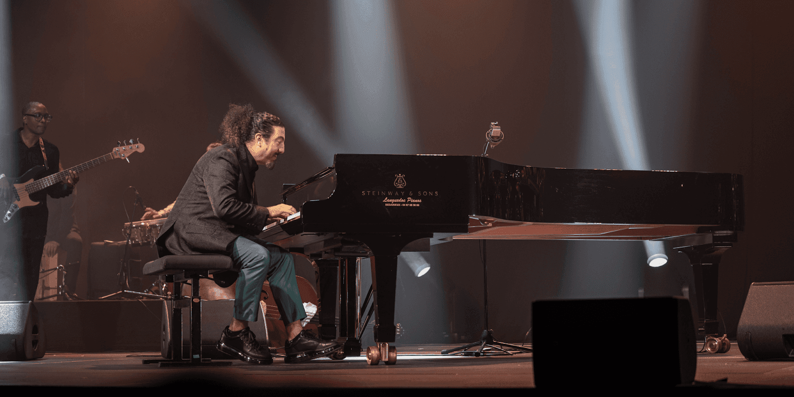 "Aleph the pianist performing live on stage, blending classical music with Middle Eastern influences during his 2025 U.S. and Europe tour."
