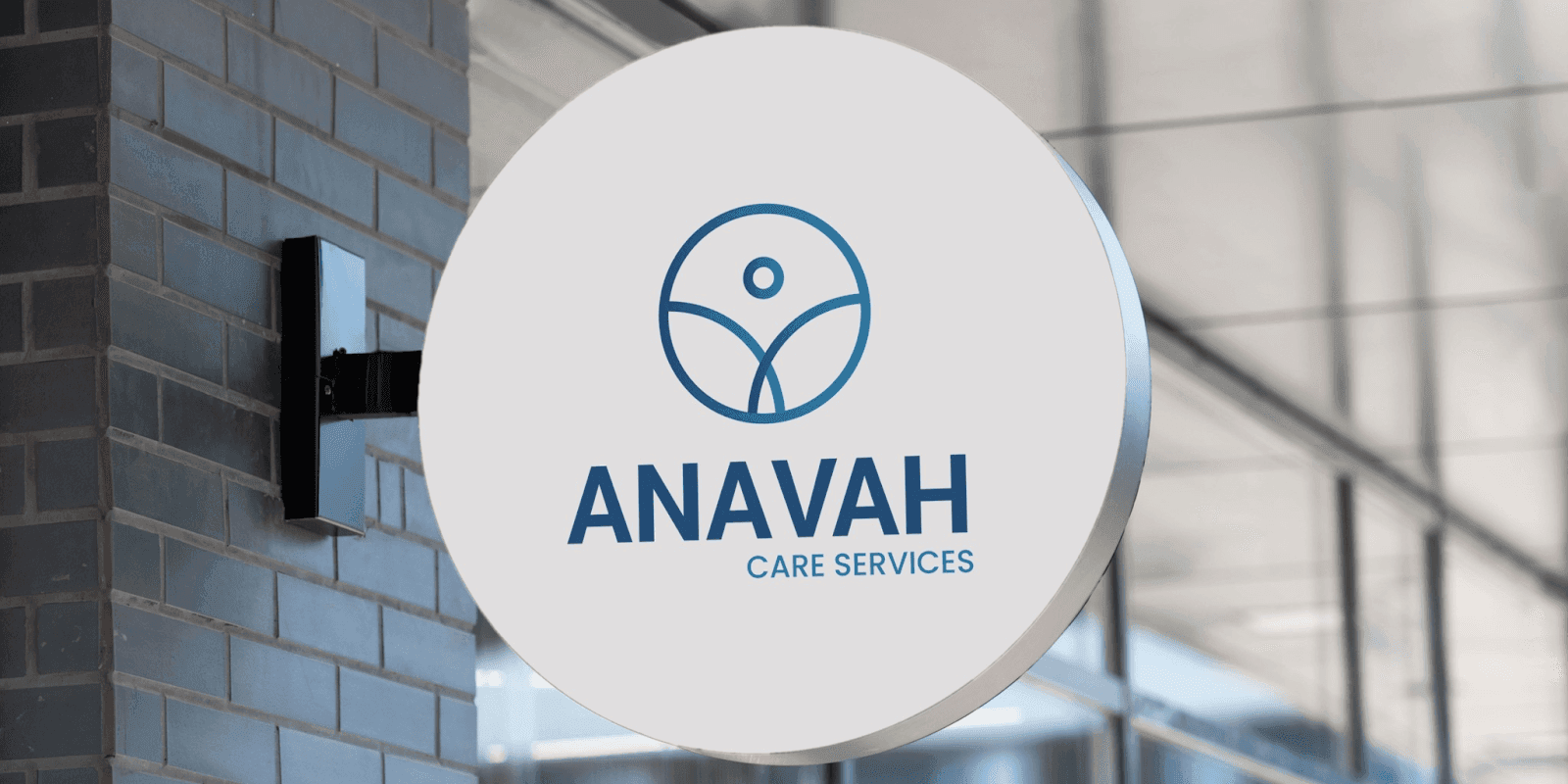 Circular sign reading “ANAVAH Care Services” representing a healthcare provider, photographed outside a building.