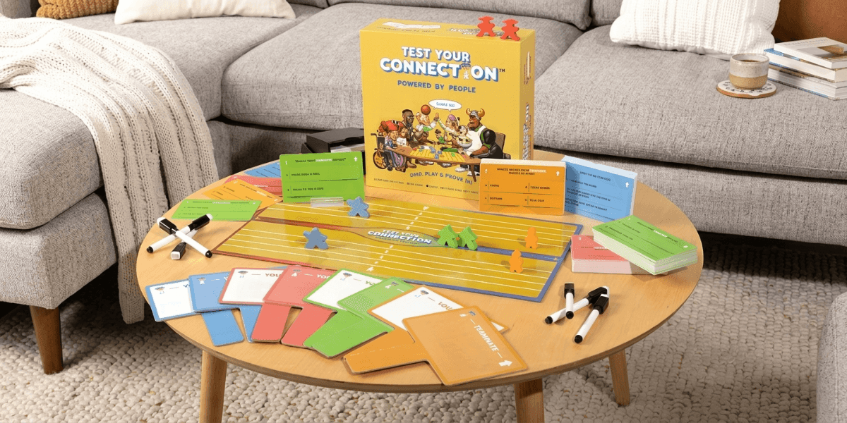 Test Your Connection board game set with question cards, game pieces, markers, and game box on a coffee table.