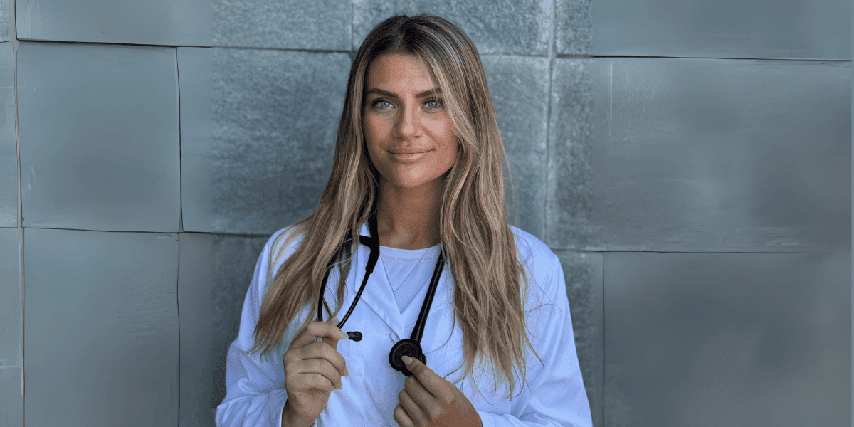 Dr. Adrienne Guthrie, functional medicine doctor, stands confidently with stethoscope, promoting personalized root-cause healing nationwide.