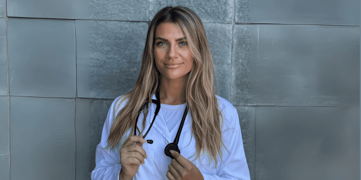 Dr. Adrienne Guthrie, functional medicine doctor, stands confidently with stethoscope, promoting personalized root-cause healing nationwide.