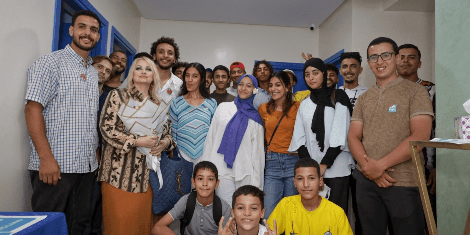 Julie Wilburn with a diverse group of students and staff at American Group International, fostering inclusive education in Morocco.