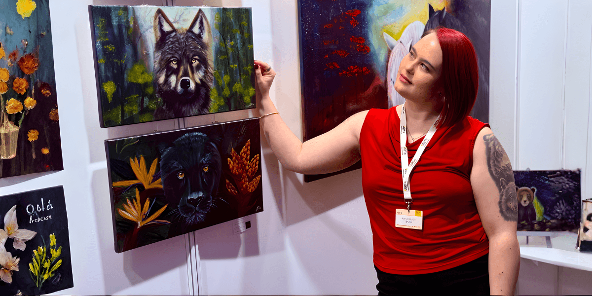AC Brune showcases her wildlife-inspired artwork at an exhibition, blending nature and emotional depth.