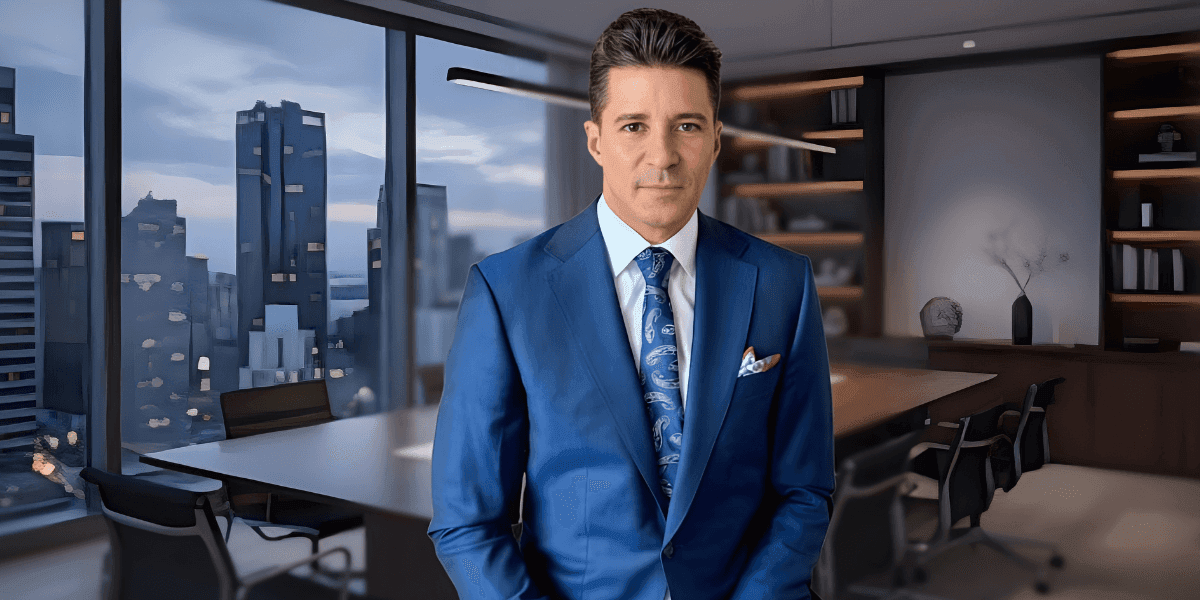 a professional man in a blue suit standing confidently in a modern office, symbolizing leadership and success.