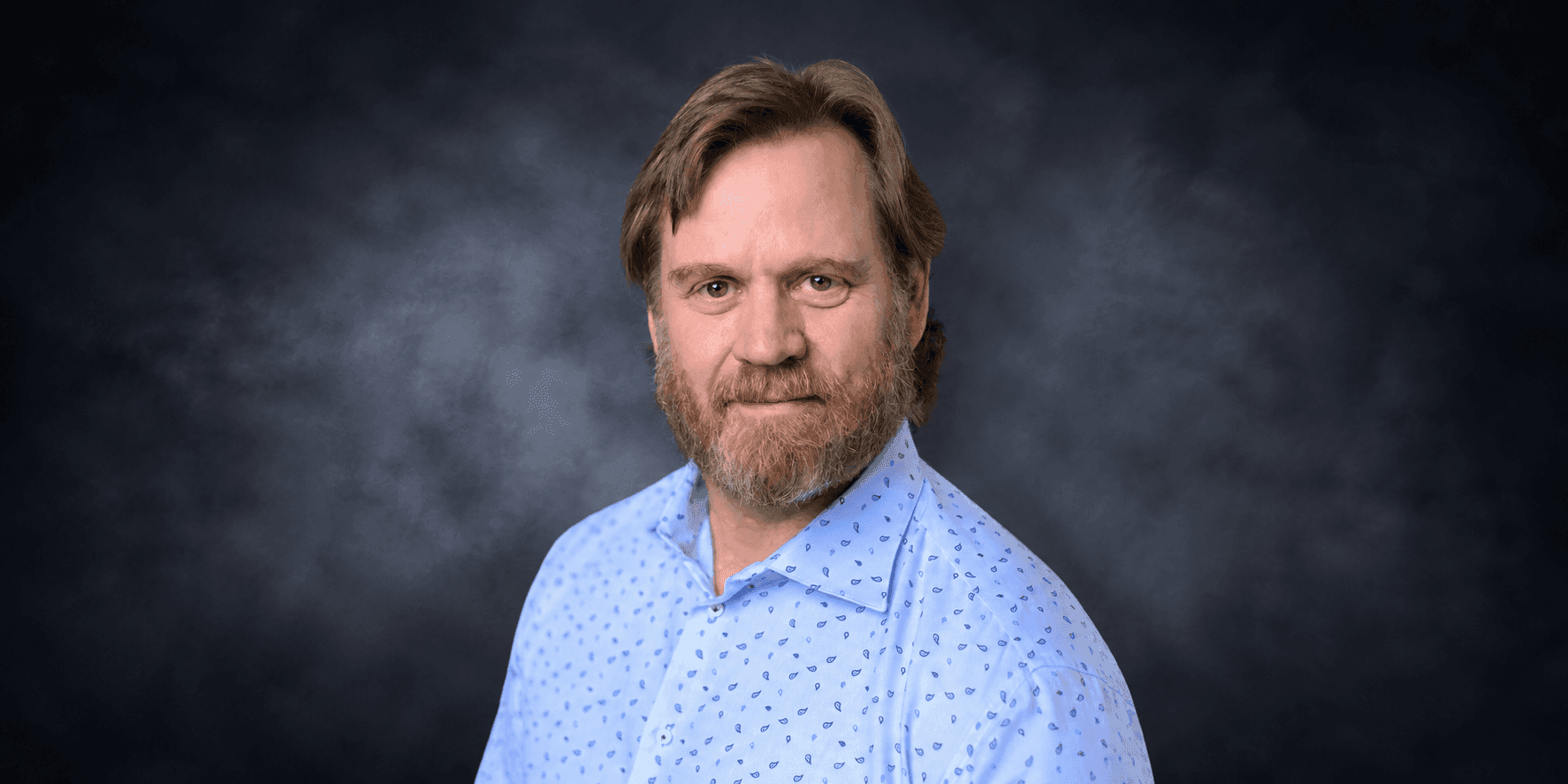 Joe John, founder and CEO of John Consulting, smiling in a professional portrait.
