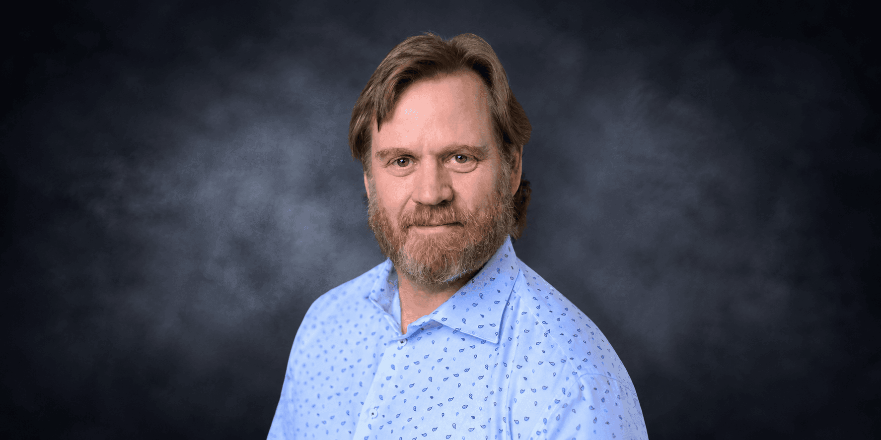 Joe John, founder and CEO of John Consulting, smiling in a professional portrait.