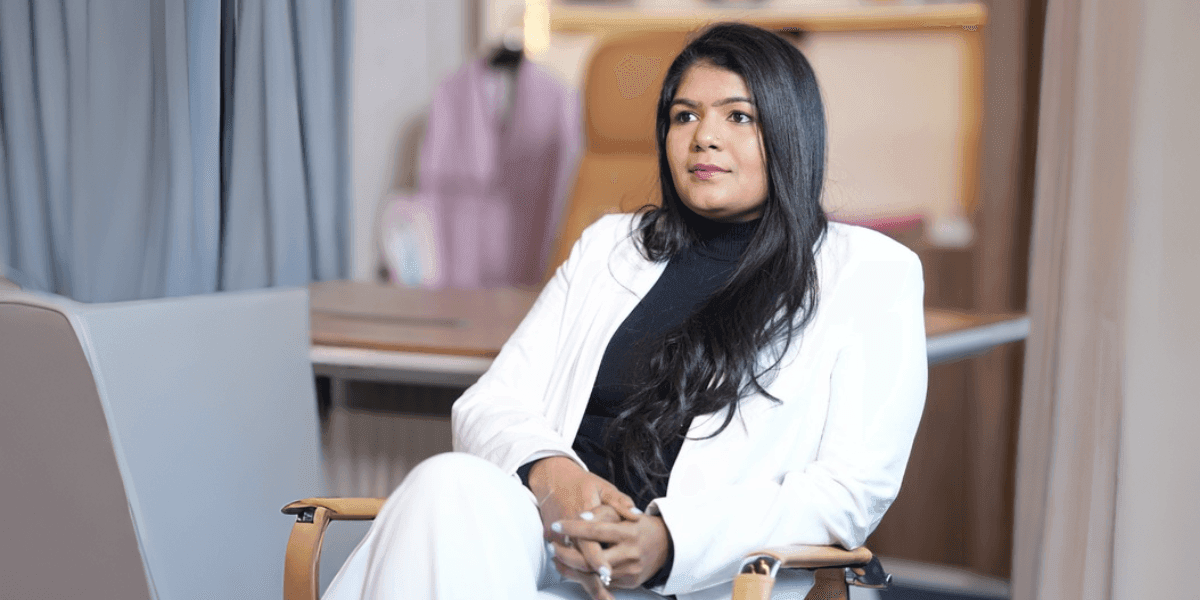Portrait of Ashwini Kotaru in white blazer, discussing AI governance and enterprise transformation.