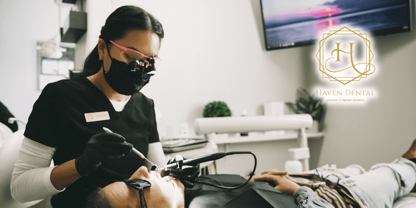 A dental professional treating a patient at Haven Dental, using modern dental equipment in a clean clinic setting.