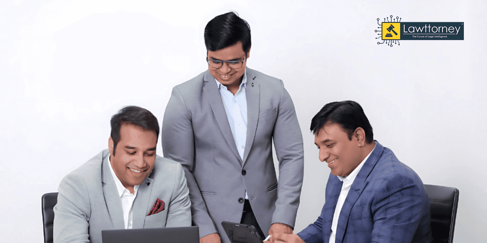 Three lawyers collaborating on laptops, representing Indian law firms adopting AI tools like Lawttorney.ai to enhance legal workflows.