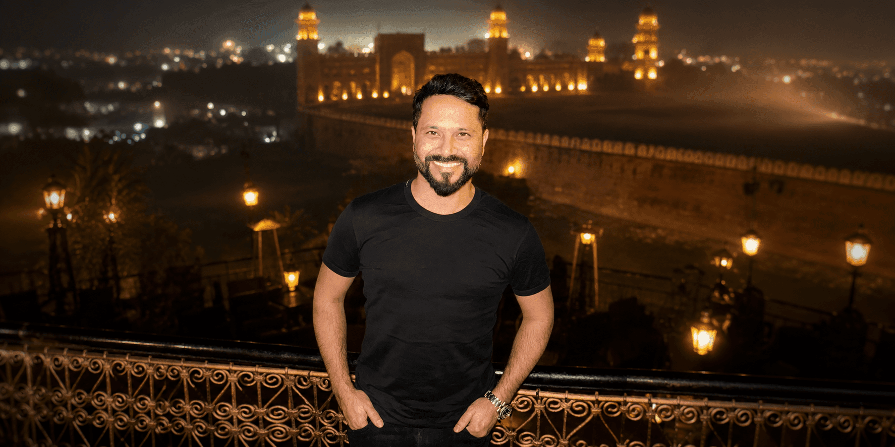 Annas Faheem stands before Lahore Fort at night, representing Pakistani entrepreneurship and global brand leadership.