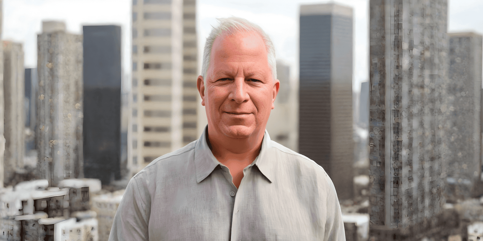 Bill Cancel, founder of The Boricuabc2 Show, standing confidently in front of a city skyline.