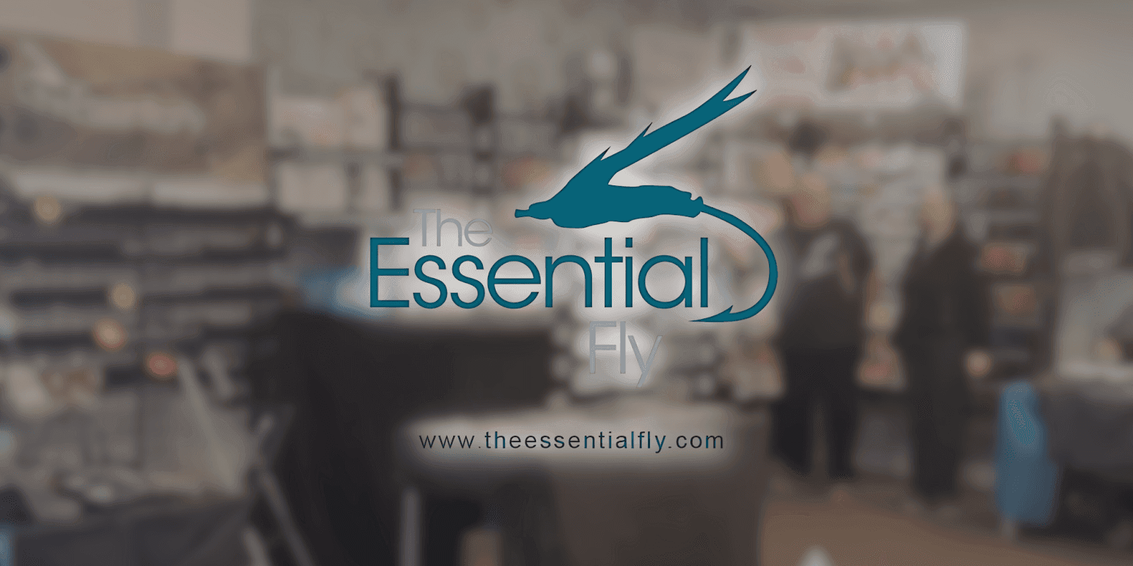 The Essential Fly logo displayed prominently on a large screen, representing a trusted hub for UK fly fishers.