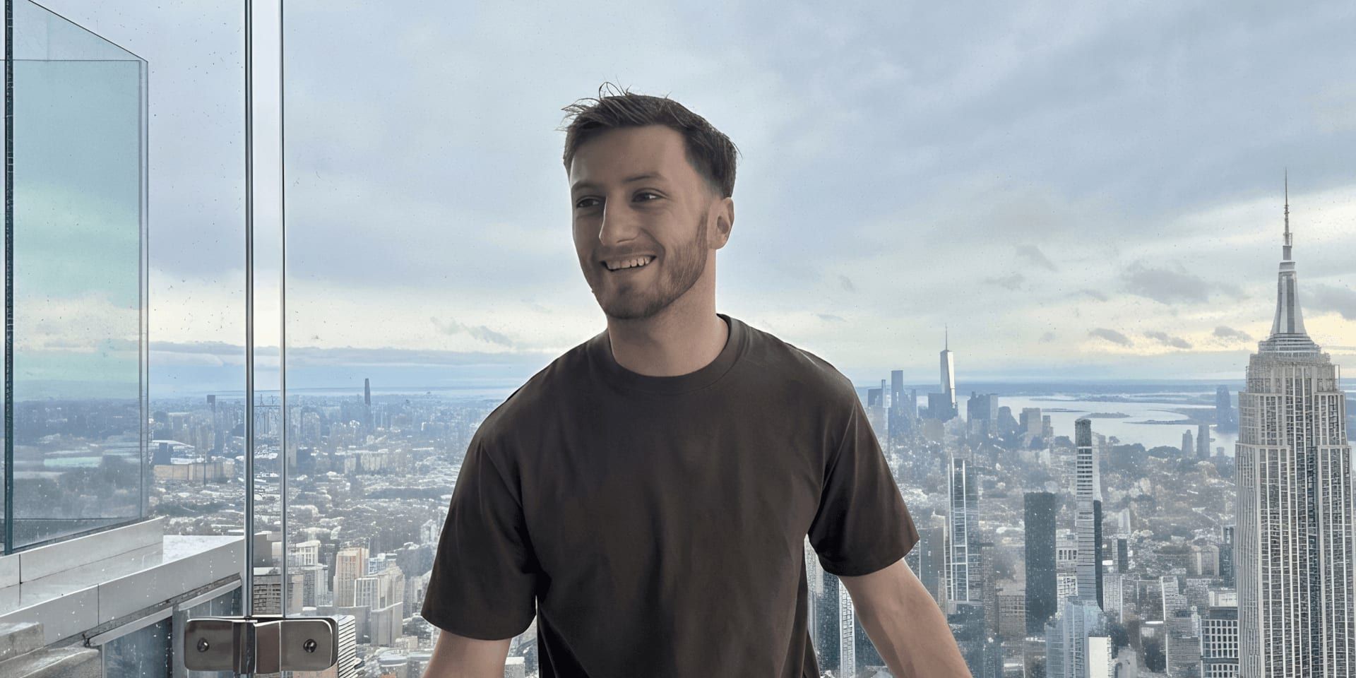 Alexander Law-Smith smiles above Manhattan skyline, representing his innovative approach to transforming mold inspection marketing and national home services diagnostics.