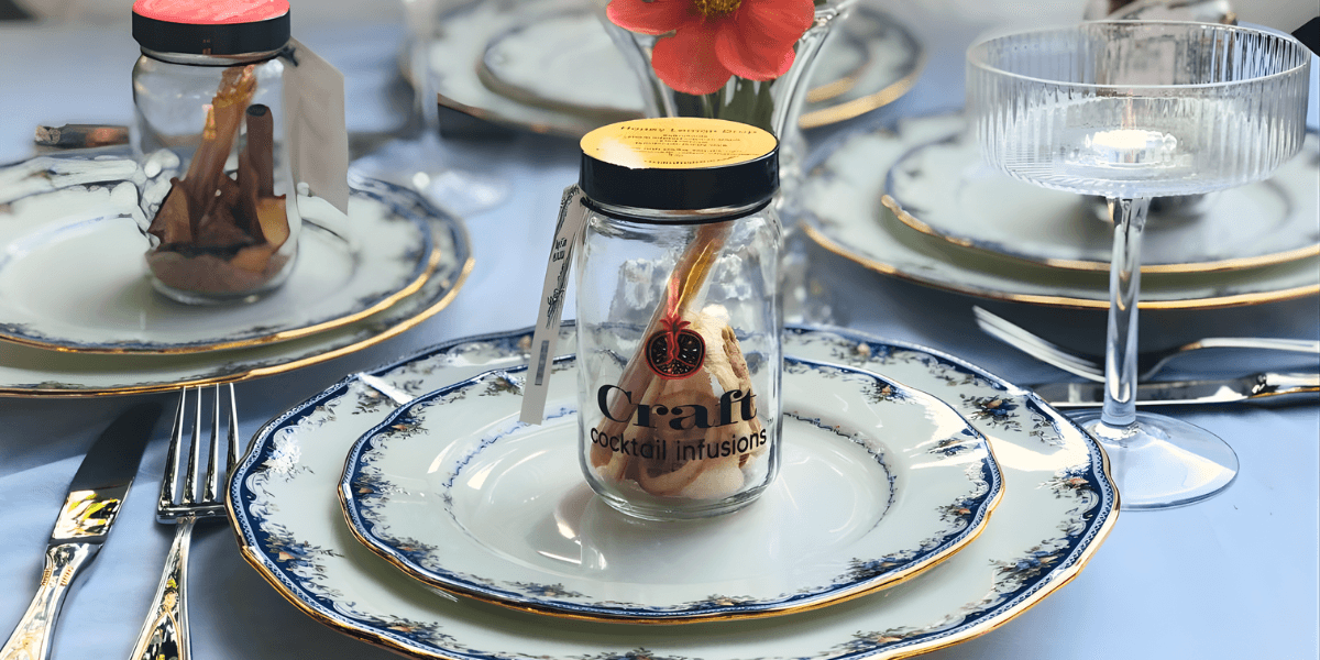 "Craft Cocktail Infusions jar displayed on an elegantly set table, showcasing unique, handcrafted cocktail ingredients for creative celebrations."