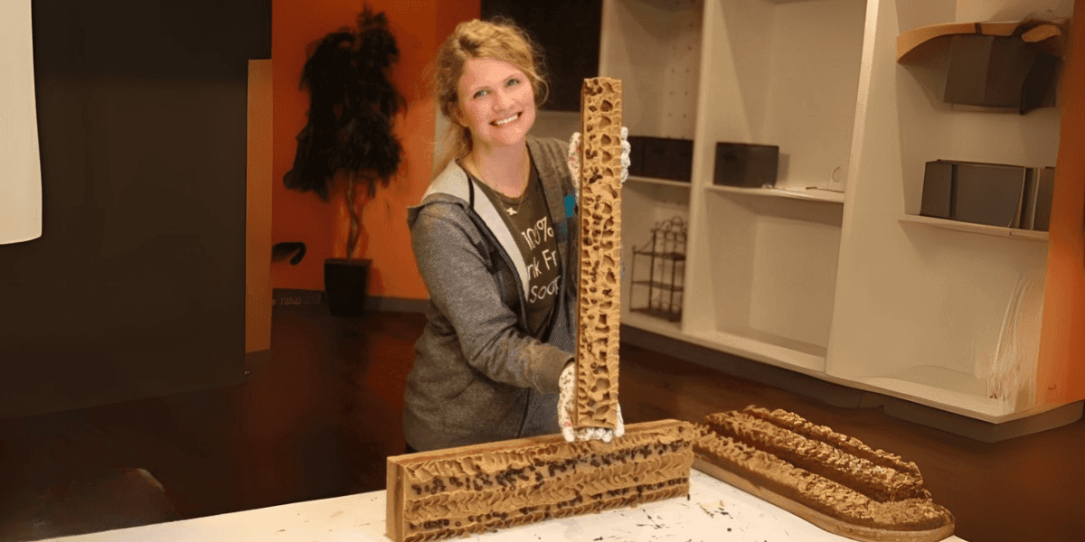 Nicole Boshell, The Messy Soap Maker, showcasing handcrafted soap at Natural Desires Soap Company with a smile.