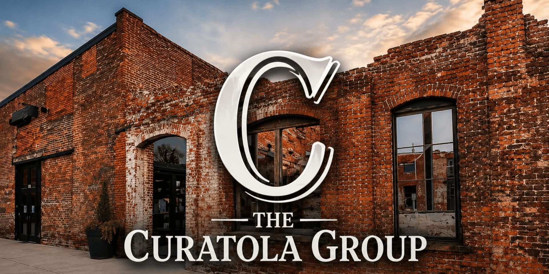 The Curatola Group logo over a restored historic brick building exterior.
