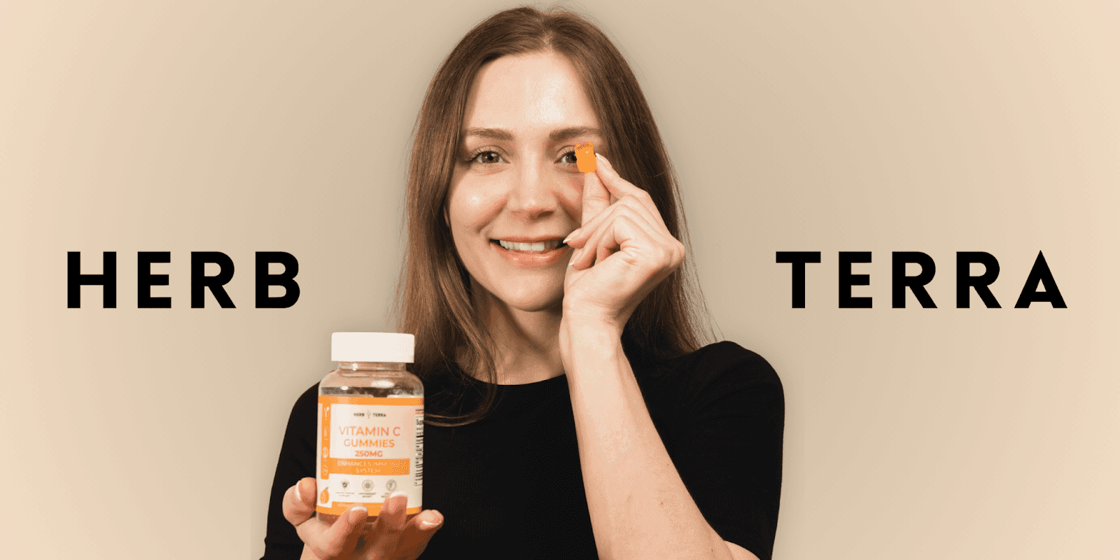 Smiling woman holding Herb Terra Vitamin C Gummies 250mg, showing one gummy for immune system support, antioxidant boost, and collagen regeneration