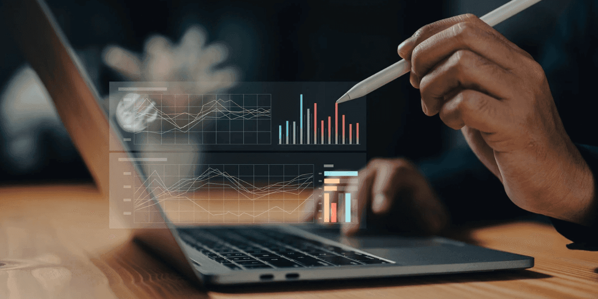 A person analyzing financial data on a laptop, representing Veridian’s precision finance and data-driven investment approach in luxury assets.