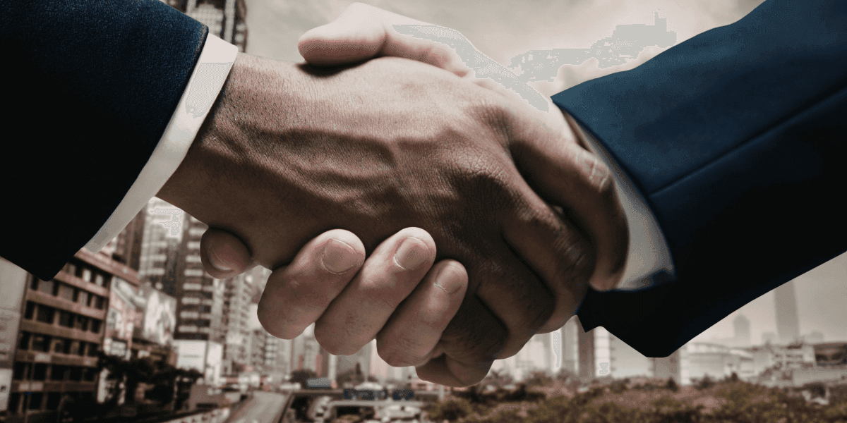 Business professionals shaking hands in a city setting, symbolizing partnership, trust, and modern business collaboration.