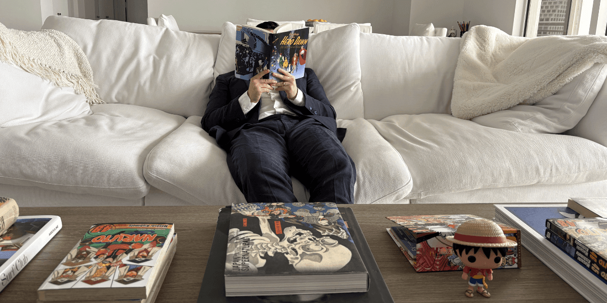 A person reading Hero Dawn in a cozy setting, reflecting the world-building and fantasy storytelling at the heart of Hero Dawn.