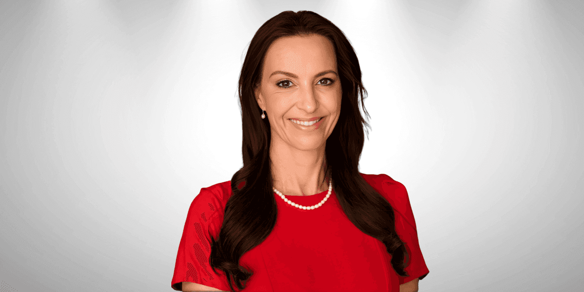 Lorna Greyling, a resilient woman in a red dress, embodying hope, joy, and strength in adversity.