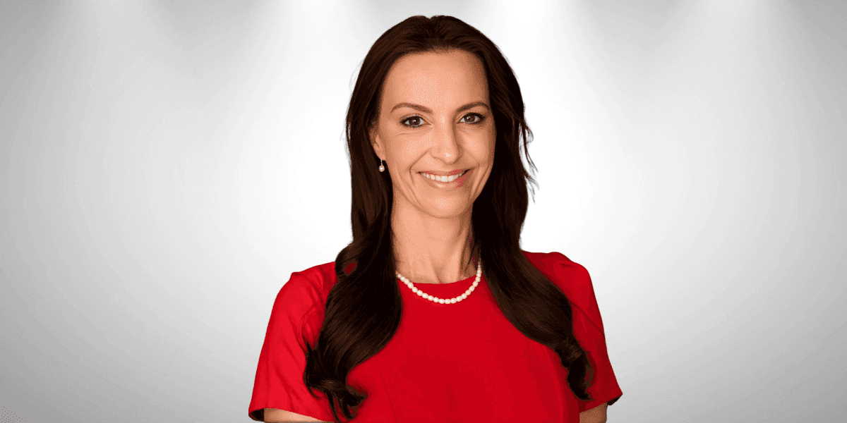 Lorna Greyling, a resilient woman in a red dress, embodying hope, joy, and strength in adversity.