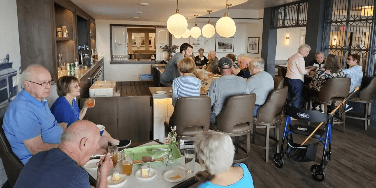 Seniors enjoying meals and socializing at The Westerly Pewaukee, highlighting community engagement and active senior living in a supportive environment.