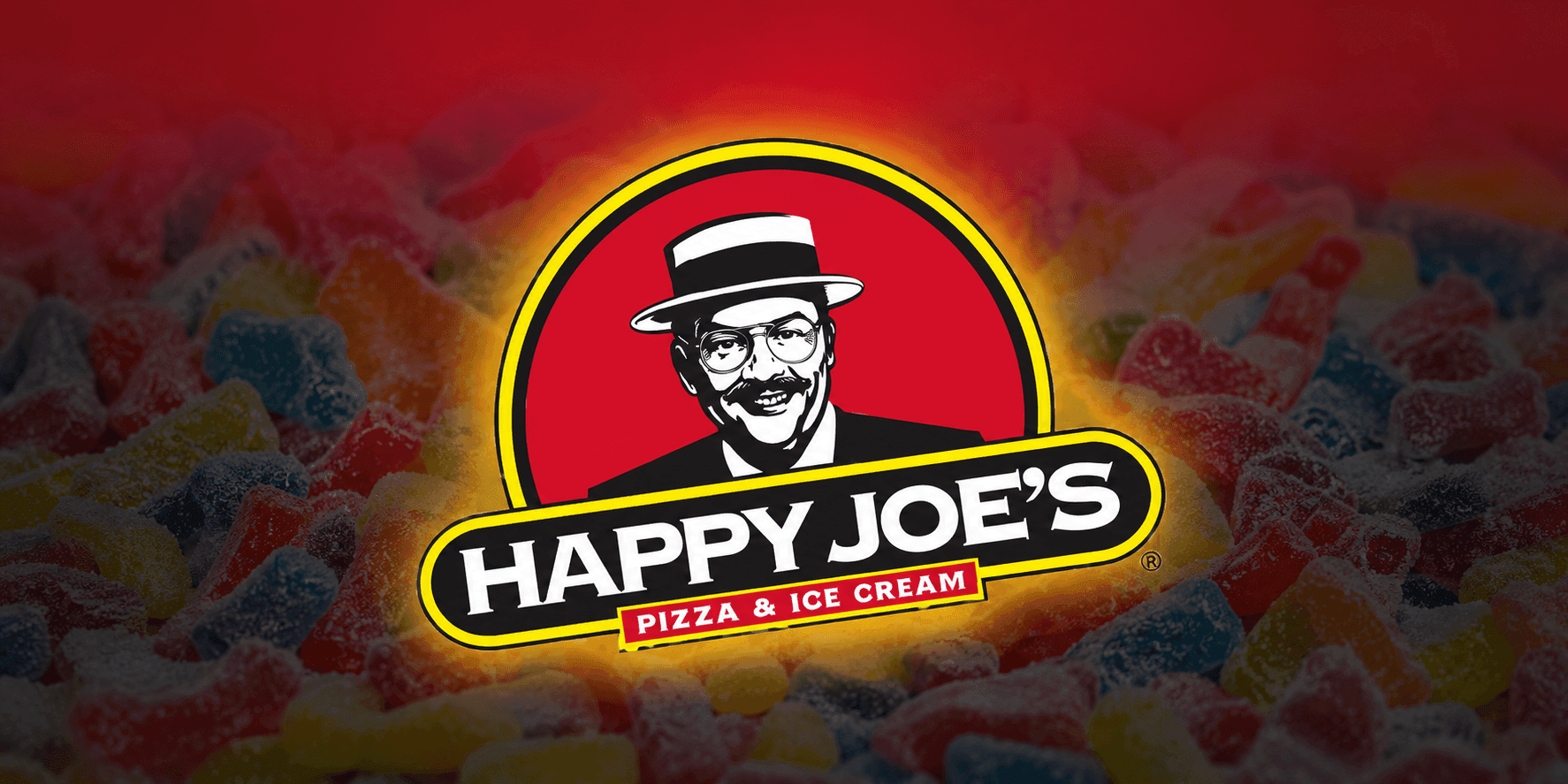 Happy Joe’s Pizza & Ice Cream logo displayed over a background of colorful gummy candies.