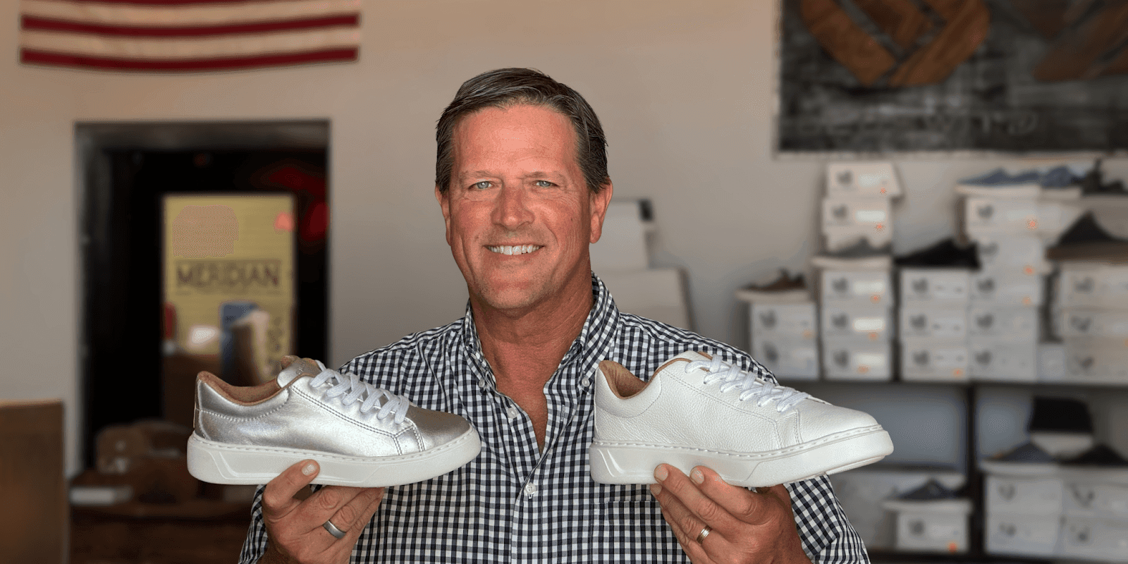 CEO Mike Van Drunen showcases BLKSWN Footwear’s American-made leather sneakers inside their shoe store.
