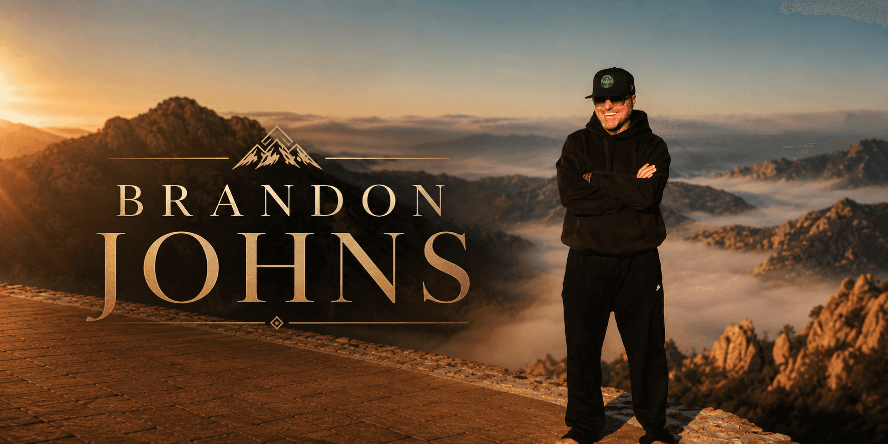 Brandon Johns standing on a mountain overlook at sunrise, promotional portrait for the Brandon from Georgia brand.