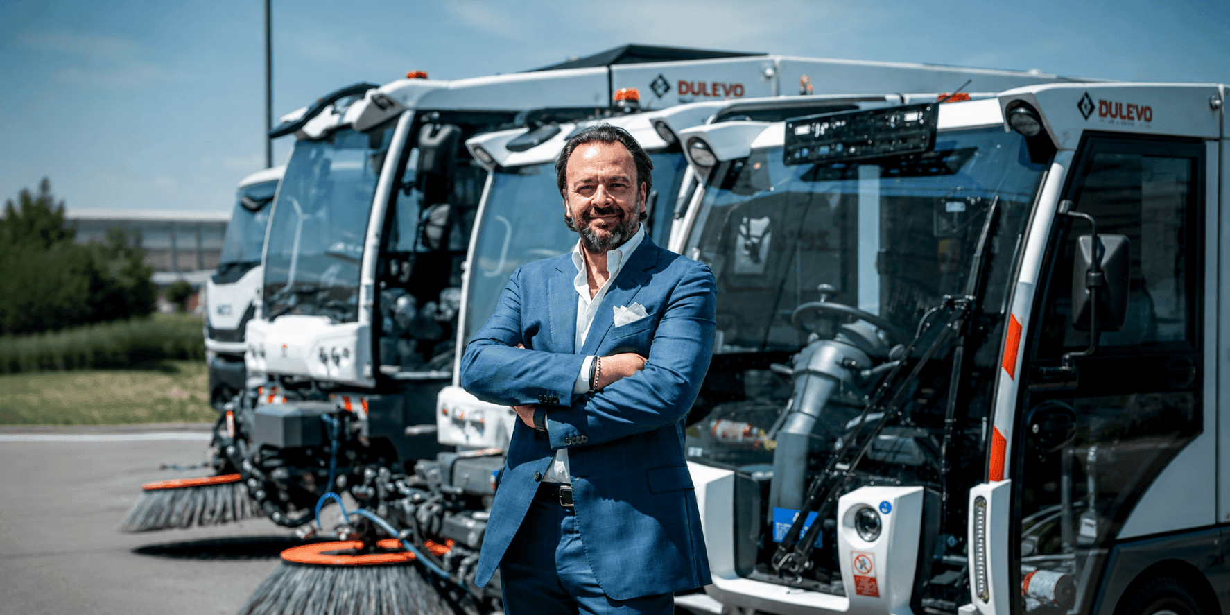 Umberto Maria Cini stands before Dulevo street sweepers at the company's manufacturing facility in Italy.