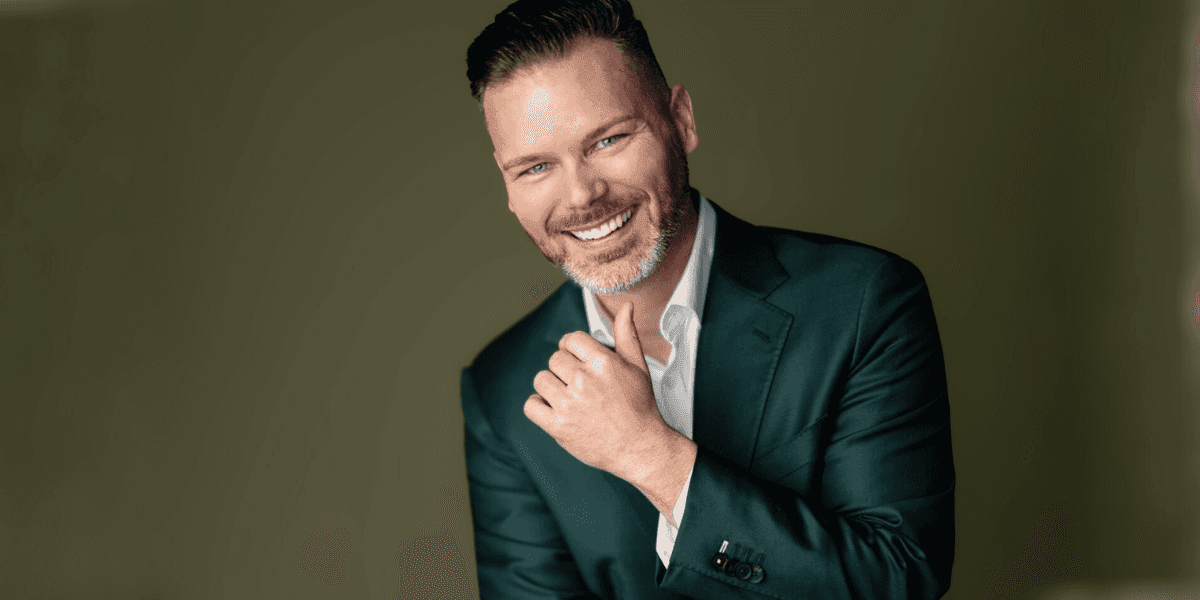 "Portrait of Justin Patton, leadership expert and author, smiling confidently in a suit, embodying trust-building and leadership."