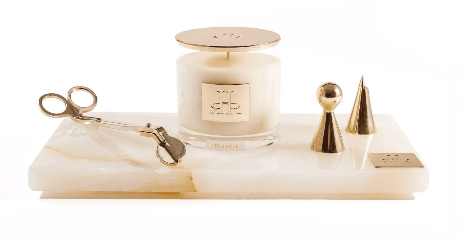RHR Luxury candle and accessories featuring elegant gold details, crystal vessel, and onyx tray, embodying craftsmanship and exclusivity.