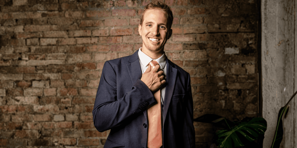 Josh Meador, mentalist and event planner, dressed in a suit, smiling and engaging, ready to transform events into unforgettable experiences.