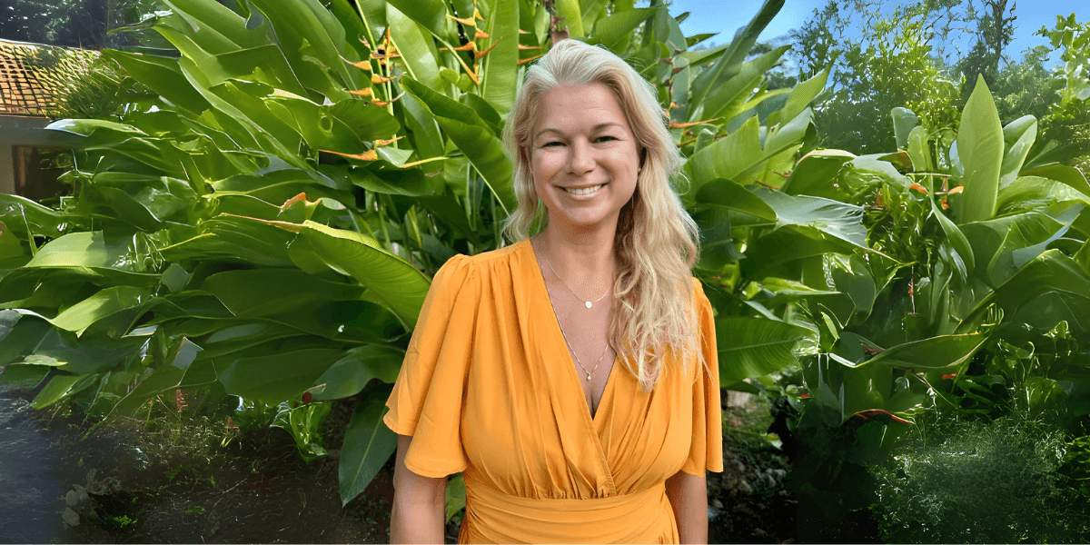 Melanie Vanhawk standing in nature, embodying her journey from trauma to holistic healing and transformation.