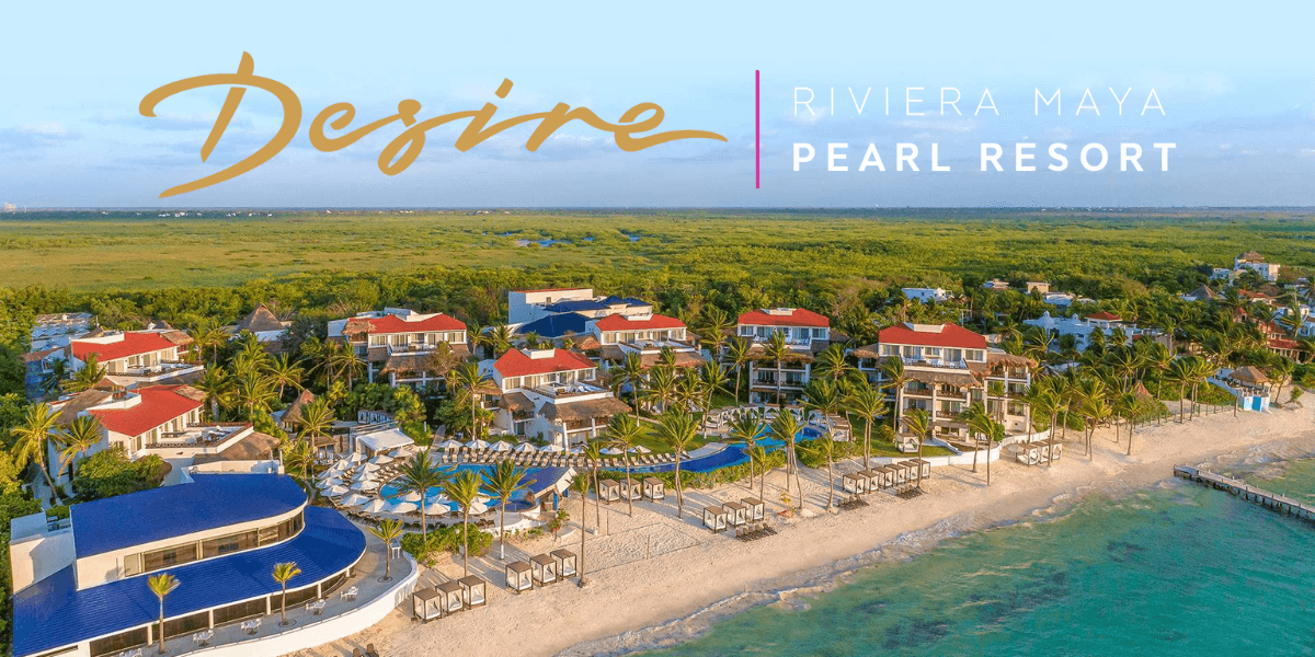 Aerial view of Desire Riviera Maya Pearl Resort beachfront, surrounded by palm trees, pools, and luxury villas.