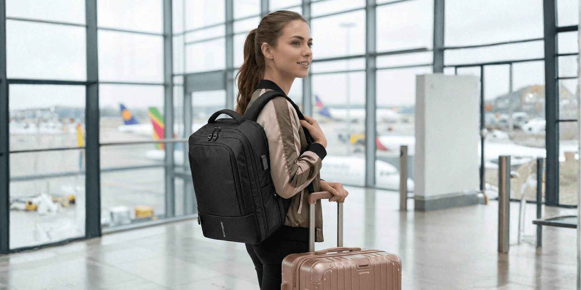 Woman with backpack and carry-on suitcase standing in airport terminal, ready for travel.
