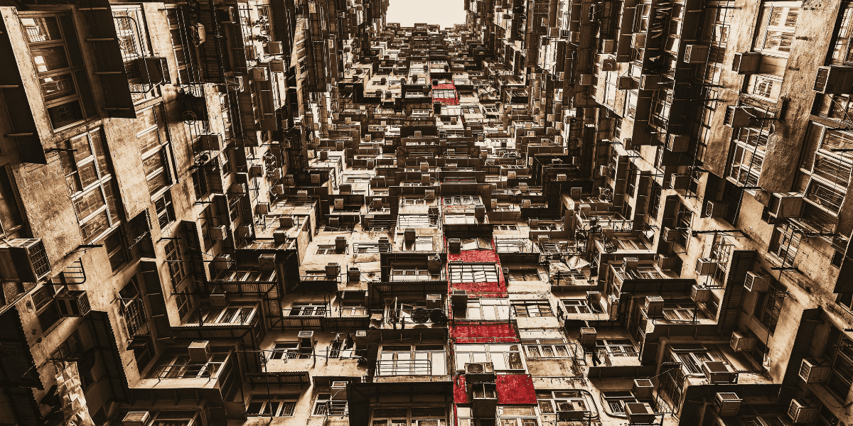 Abstract architectural photograph with layered apartment buildings and highlighted red balconies.