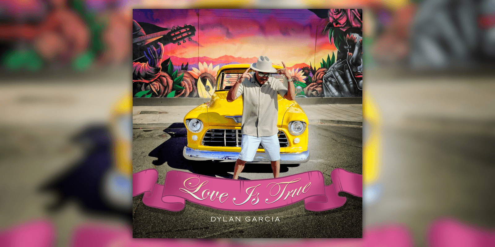 Dylan Garcia posing in front of a colorful mural, wearing a hat and casual attire, next to a yellow vintage car."