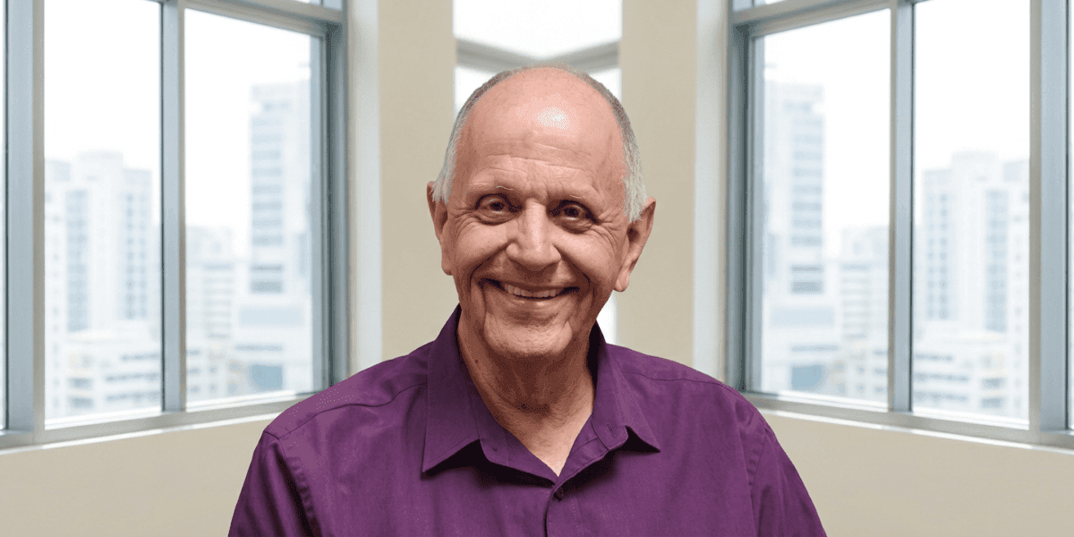 Portrait of registered psychologist Hein Roth, founder of RECOVER mental wellness app, smiling indoors.