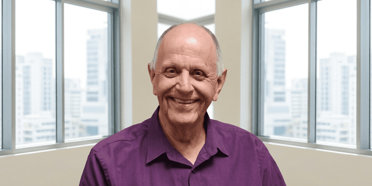 Portrait of registered psychologist Hein Roth, founder of RECOVER mental wellness app, smiling indoors.